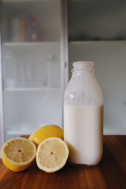 jar of milk next to lemons