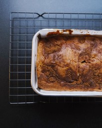 cinnamon swirl pound cake loaf sitting on cooling rack