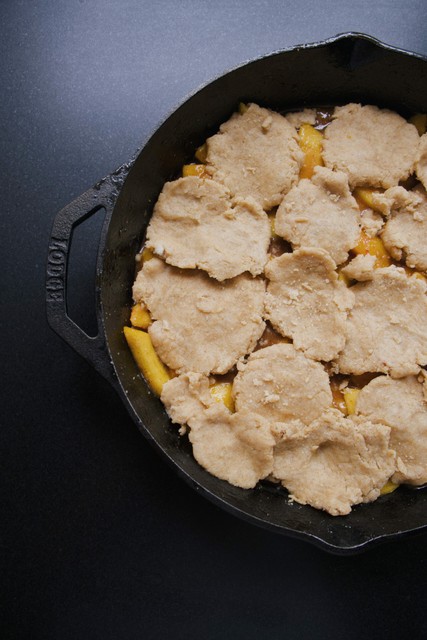 unbaked peach cobbler in skillet