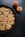 peach cobbler in skillet next to peaches